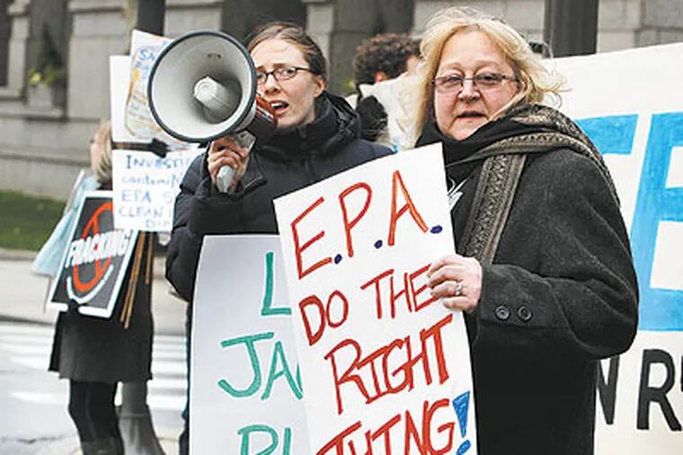 Dimock resident Julie Sautner (right) protesting last Friday at the Academy of Natural Sciences in Phila. before an appearance by EPA chief Lisa Jackson. (Jacqueline Larma / Associated Press)
