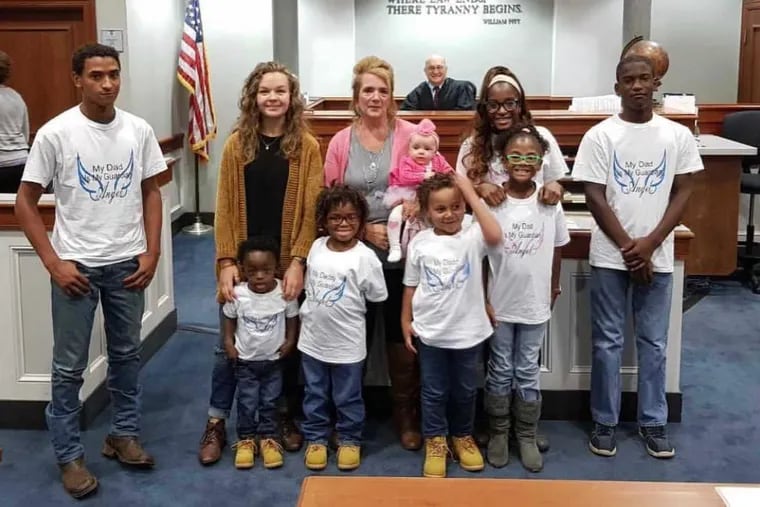 Karen with nine of her 13 children, at Olivia's adoption finalization in October: (in back, from left) Christian, Sarah, Karen holding Olivia, Jayda and Jacob; and (in front, from left): Matthew, Isaiah, Noah, and Gracie.