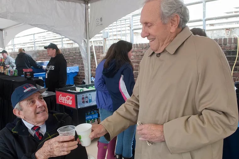 Former Penn football players Ernie Prudenti of Wallingford (left) and Dick Rosenbleeth of Bala Cynwyd toast before the Dartmouth-Penn game at  Franklin Field.  (AVI  STEINHARDT / For The  Inquirer)