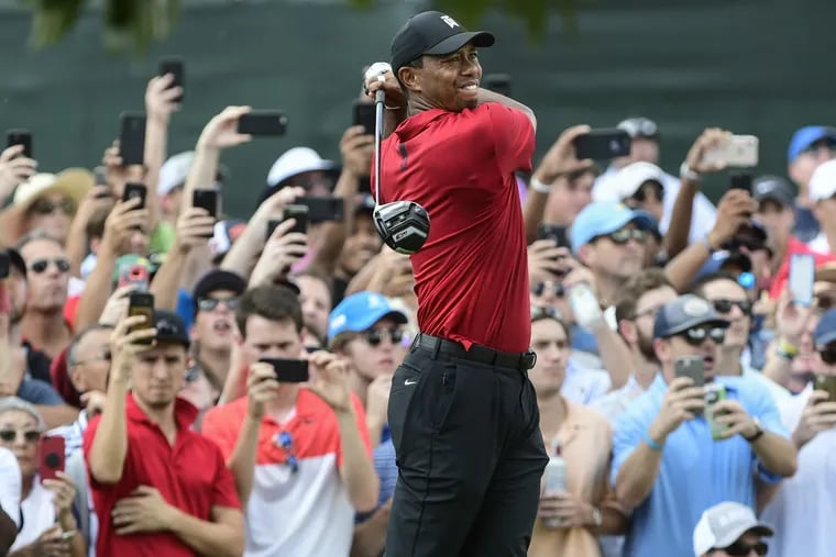 Tiger Woods hits from the third tee during the final round of the Tour Championship on Sunday.