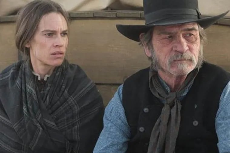 Tommy Lee Jones and Hilary Swank in "The Homesman," a film that centers around the wagon-transport of three women driven mad by pioneer life.