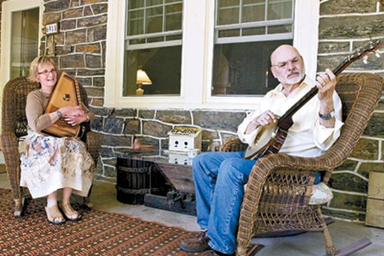 Sara and Harry Robbins' play folk tunes on the porch of their West Mount Airy home. (Ron Tarver / Staff Photographer)