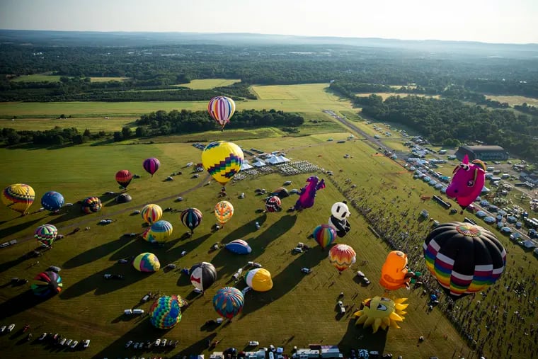 Hot air balloons in all their colorful glory begin to ascend at the start of the New Jersey Lottery Festival of Ballooning in Whitehouse Station, N.J., on Saturday, July 24, 2021.