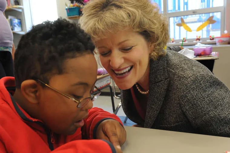Bancroft CEO Toni Pergolin with Makhi Terrell, 7, at the Bancroft School in Cherry Hill. The nonprofit was in tough financial shape when she arrived there as chief finance officer in 2004.