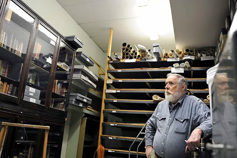 Leonard Irwin, a volunteer with the Camden County Historical Society pauses in the vault August 6, 2014. The Society has objects rarely displayed, especially while the site undergoes the restoration following broken pipes and water damage last winter's severe cold.  ( TOM GRALISH / Staff Photographer )