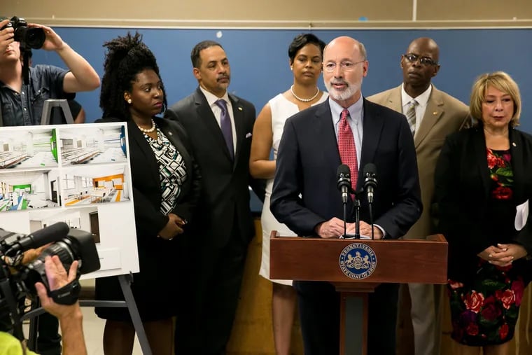 Gov. Tom Wolf, pictured at a press conference at a Philadelphia school in June, says he's reversed his predecessor's cuts to education.