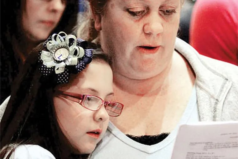 Donna Siemien and daughter Caitlin, a third-grader at St. Laurentius School, attend a prayer meeting yesterday celebrating the appeal win. (Laurence Kesterson / Staff Photographer)