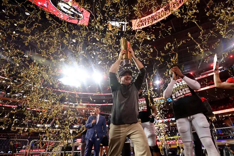 Georgia coach Kirby Smart lifts the national championship trophy after his team's rout of TCU in the College Football Playoff final on Jan. 9.