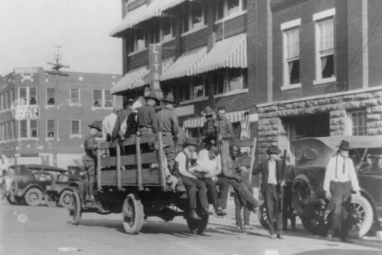 A truck near Litan Hotel carries soldiers and African Americans during Tulsa, Okla., race riot in 1921.