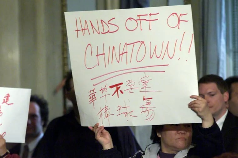 A Chinatown resident protests a proposed Phillies stadium in the neighborhood in 2000. A ballpark was a threat to Chinatown's existence then, and a Sixers stadium would be a threat now, writes Harry Leong, president of the Philadelphia Suns.