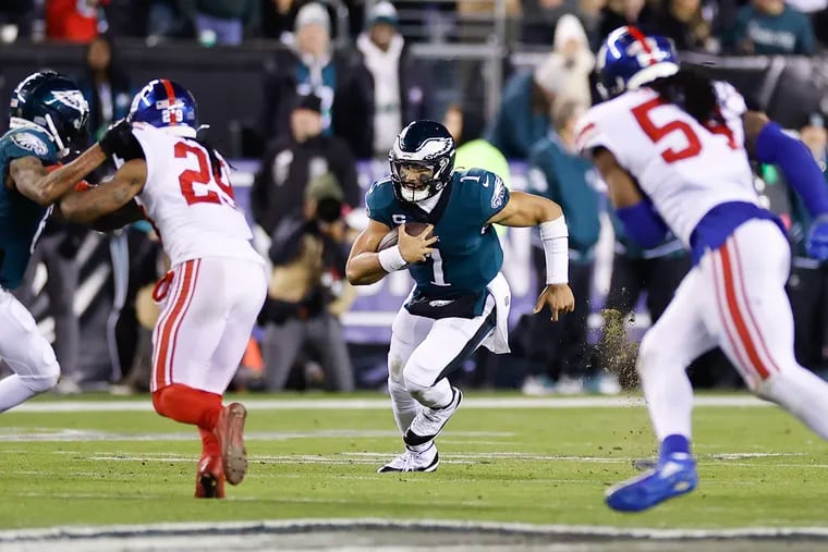 Eagles quarterback Jalen Hurts runs with the football against the New York Giants on Saturday night.