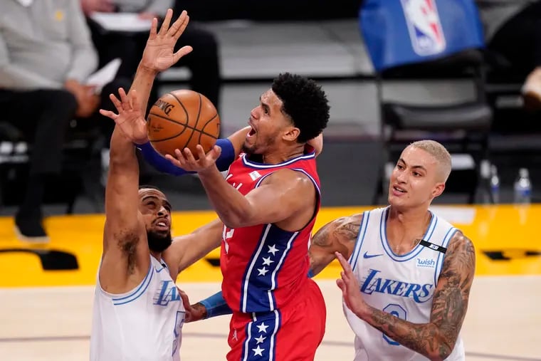 Sixers forward Tobias Harris, shoots as Los Angeles Lakers guard Talen Horton-Tucker, left, and forward Kyle Kuzma defend during the second half March 25 in Los Angeles.