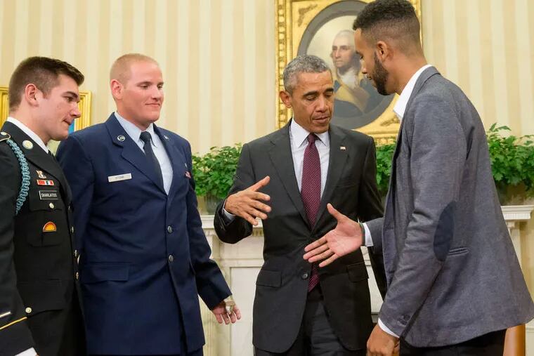President Obama prepares to shake hands with Anthony Sadler while honoring him, National Guardsman Alek Skarlatos, and Airman First Class Spencer Stone in the Oval Office.