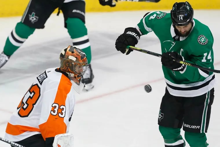 Philadelphia Flyers goaltender Cam Talbot (33) defends the goal against Dallas Stars left wing Jamie Benn (14) during the first period of an NHL hockey game in Dallas, Tuesday, April 2, 2019. (AP Photo/LM Otero)