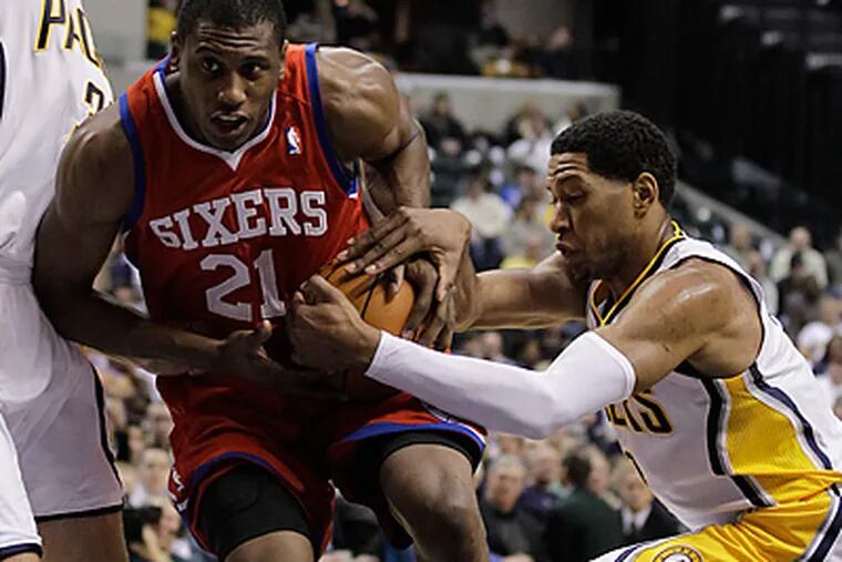 76ers forward Thaddeus Young is defended by Indiana Pacers forward Danny Granger. (AP Photo/Darron Cummings)