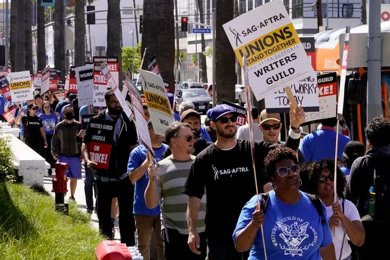 Members of the SAG-AFTRA union join a picket line in support of the striking Writers Guild of America outside the Netflix Inc. building in Los Angeles in May. After failing to reach a contract with major studios, SAG-AFTRA announced Thursday that they will also move forward with a work stoppage.