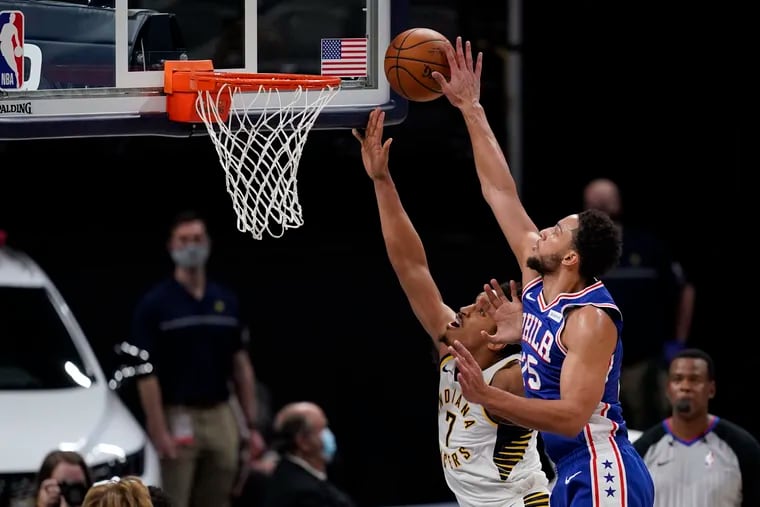 Indiana Pacers' Malcolm Brogdon (7) has his shot blocked by Philadelphia 76ers' Ben Simmons (25) during the first half on Friday, Dec. 18, 2020, in Indianapolis.