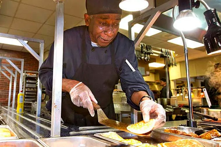 John Ham restocks the pancakes at Golden Corral, which now has breakfast all day. (CHARLES FOX/Staff Photographer)