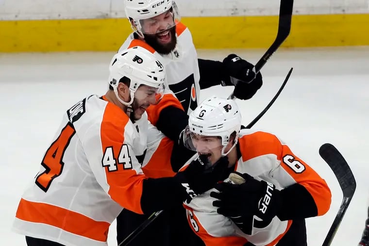 Flyers defenseman Travis Sanheim (6) celebrates his winning goal with teammates Phil Varone (44) and Radko Gudas (3) after Thursday's 3-2 overtime victory in Boston.