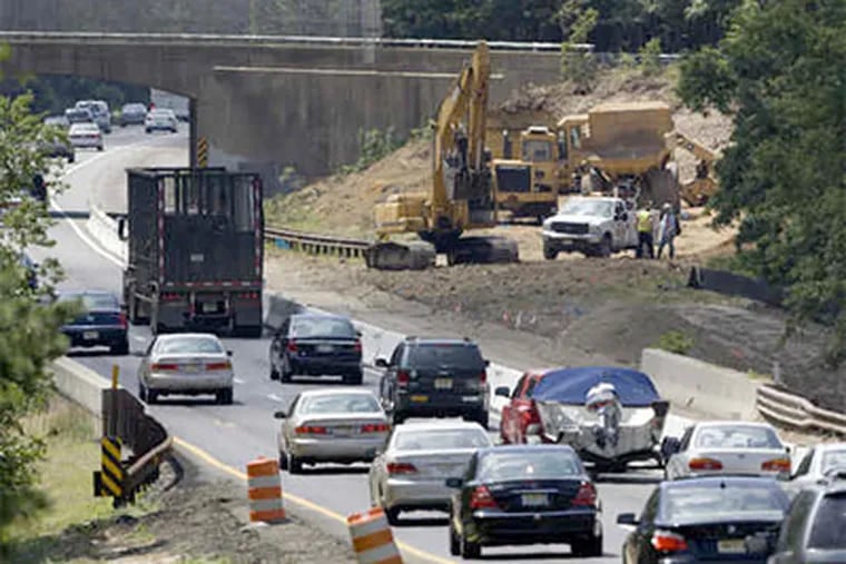 Southbound traffic slows around construction on the Garden State Parkway at Milepost 80near Toms River, N.J. Work to add lanes between there and Exit 63 began last week. (Ed Hille / Staff Photographer)