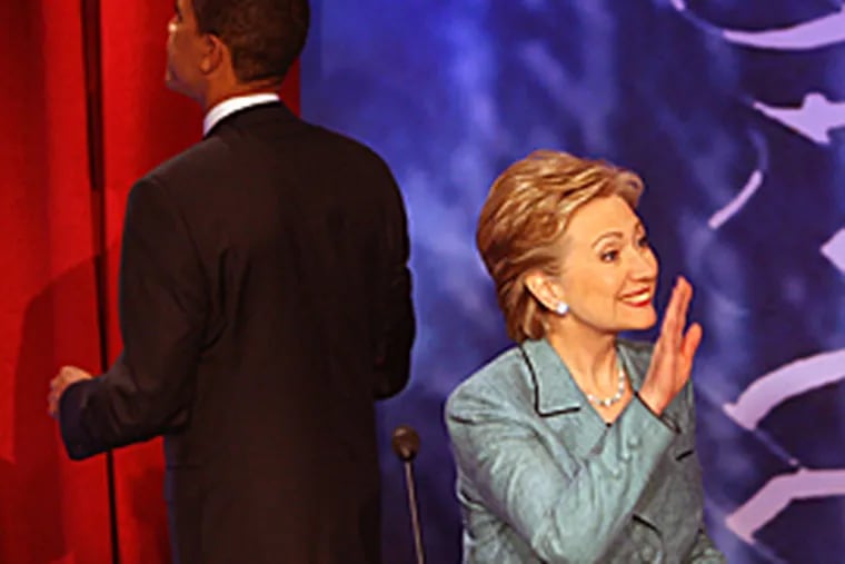 Sen. Hillary Clinton waves to her daughter after the debate, as Sen. Barack Obama walks off to visit the audience. (Michael Bryant / Inquirer)
