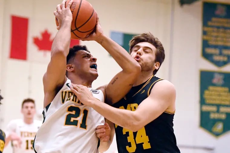 Vermont's Justin Mazulla is guarded by UMBC's Matteo Picarelli, right.