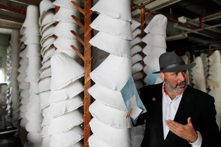 Don Rongione, the president and CEO of Bollman Hat Company, Adamstown, Pa., also the president & founder of American Made Matters, talks about hats next to a drying rack of hat bodies. Friday, November 14, 2013. (MICHAEL S. WIRTZ/Staff Photographer)