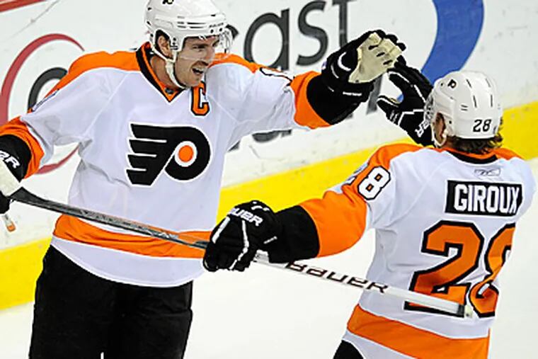 Flyers center Mike Richards and Claude Giroux, right, have both been productive for the Flyers. (AP Photo/Nick Wass)