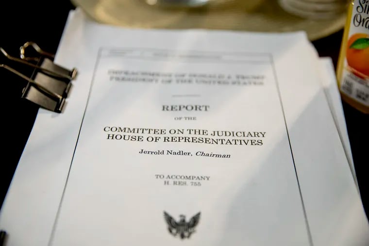 A copy of the House Judiciary Committee report on the impeachment of President Donald Trump sits on the witness table during a House Rules Committee hearing on the impeachment against President Donald Trump, Tuesday, Dec. 17, 2019, on Capitol Hill in Washington. (AP Photo/Andrew Harnik)