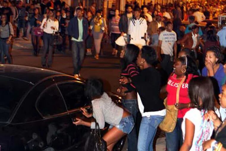 Young people swarmed South Street in a flash mob incident the night of March 20. ((Laurence Kesterson / Staff Photographer)