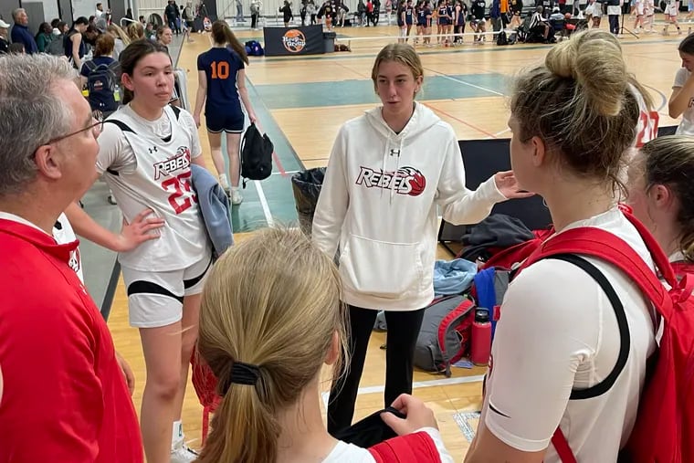Lucy Olsen talks to the Lady Runnin' Rebels 16U team after a game on May 5.