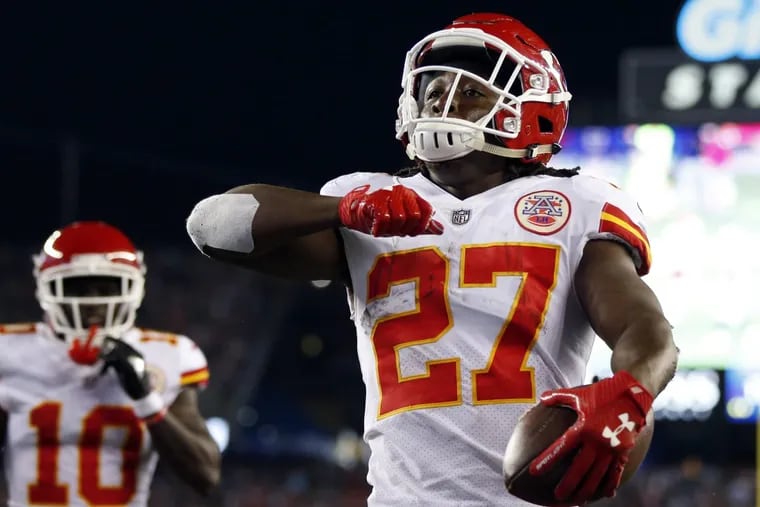 Kansas City Chiefs running back Kareem Hunt (27) celebrates his touchdown against the New England Patriots during the first half of an NFL football game on Thursday.