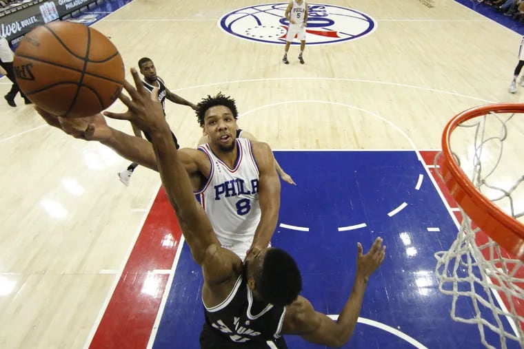 Philadelphia 76ers' Jahlil Okafor goes up for the shot with Brooklyn Nets' Thaddeus Young defending. The 76ers won 103-98.