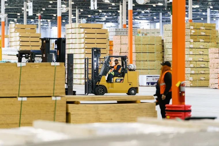 An employee operates a forklift inside the Home Depot flatbed distribution center in Stonecrest, Ga., on Nov. 30, 2021. CREDIT: Bloomberg photo by Elijah Nouvelage.