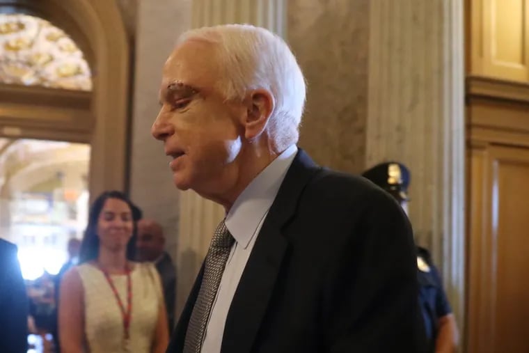 With a scar from surgery still visible on his face, John McCain arrives at Capitol Hill to vote in favor of a measure in the process to abolish Obamacare.