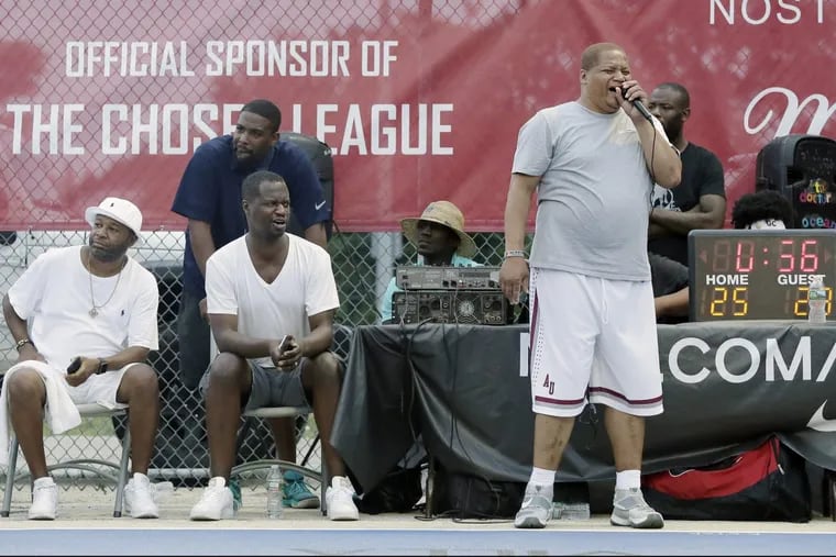Chosen League founder Rahim Thompson (seated second from left) watches the action while announcer Donald Kenner (standing on right) describes the action at 10th and Olney.