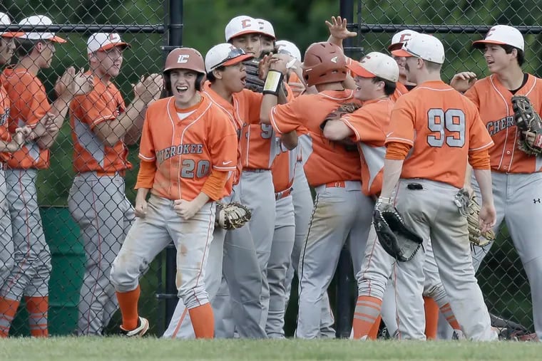 Cherokee players surround Jake Prince (obscured), who scored Cherokee’s third run at Clearview.