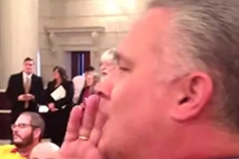 United Food & Commercial Workers Union leader Wendell Young IV shouts down a speaker in the capitol rotunda who was in favor of privatizing the state's liquor stores. (Still from YouTube video)