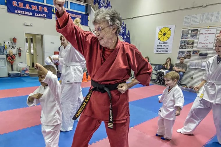 Helen Dugan, owner of karate school Champs Achievers, demonstrates poses to 6-year-old Andrew Shumate and other students on Monday, March 9, 2015, during class in Lenexa, Kan. The 80-year-old grandmother is a third-degree black belt and teaches karate classes exclusively to people with special needs. (Allison Long/Kansas City Star/TNS)