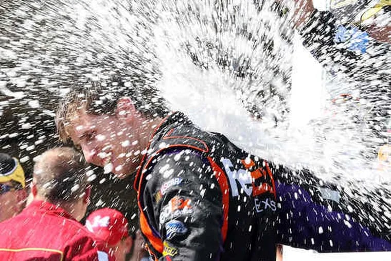 Denny Hamlin gets a champagne shower after winning at Pocono. &quot;I think only half of me was driving the car for most of the day,&quot; said Hamlin, whose grandmother died last week.