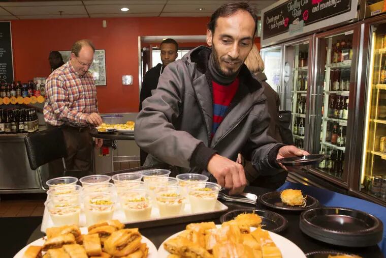 Sameer Dahan serves up his delicious desserts at the Trolley Car Diner, during a dessert tasting, in Philadelphia, February 7, 2017. Dahan, of Syria, was a tailor in his homeland but learned to bake to make ends meet as a refugee.