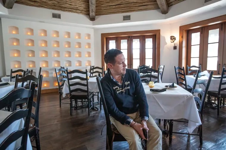 Bar manager Paul Moran sits in an empty Besito restaurant in the Suburban Square shopping center in Montgomery County. All but one reservation had been canceled for Sunday, Moran said; usually there's a very brisk lunch crowd on Sundays.