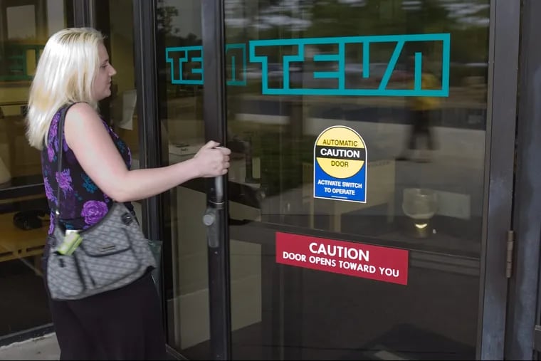 An unidentified employee enters the main entrance to Teva's North American headquarters, 1090 Horsham Road, in Montgomery County. Israel-based Teva is the largest maker of generic pharmaceuticals in the world.
