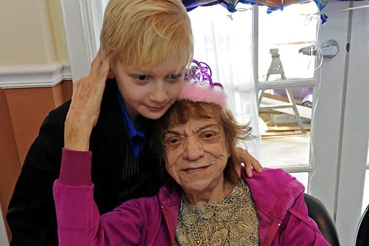 Sandra Lydell celebrates her 100th birthday with guest John Markowitz, 9, at a party at her senior living complex in Mays Landing, NJ on Jan. 4, 2014. ( APRIL SAUL  / Staff )