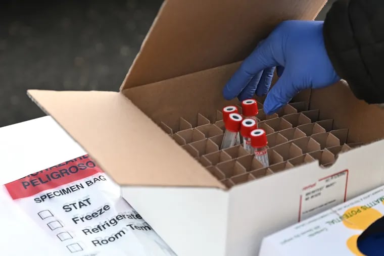 Vials for contained COVID-19 test swabs at a drive-through testing site in Cherry Hill in December.