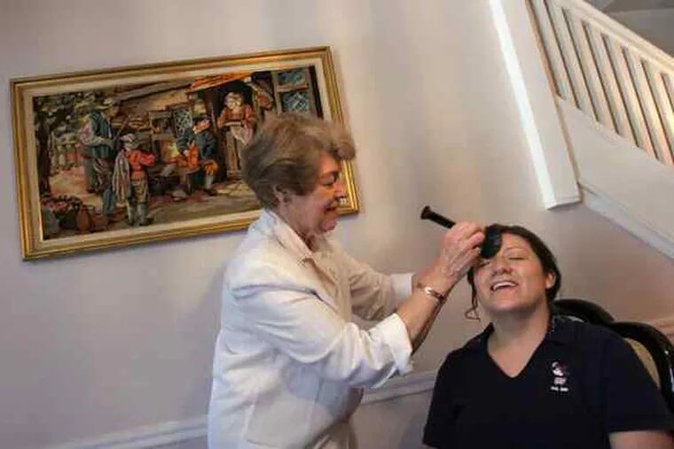 Maria Villacreses at home in Allentown gets wedding-day makeup help from Marilyn Shive. Villacreses, who earns credits as a bilingual medical interpreter and by offering rides and pet-sitting, figures she saved about $2,000 on her wedding.