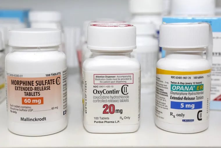 Containers of the opioid-containing drugs morphine sulfate, OxyContin and Opana, in a 2013 photo.