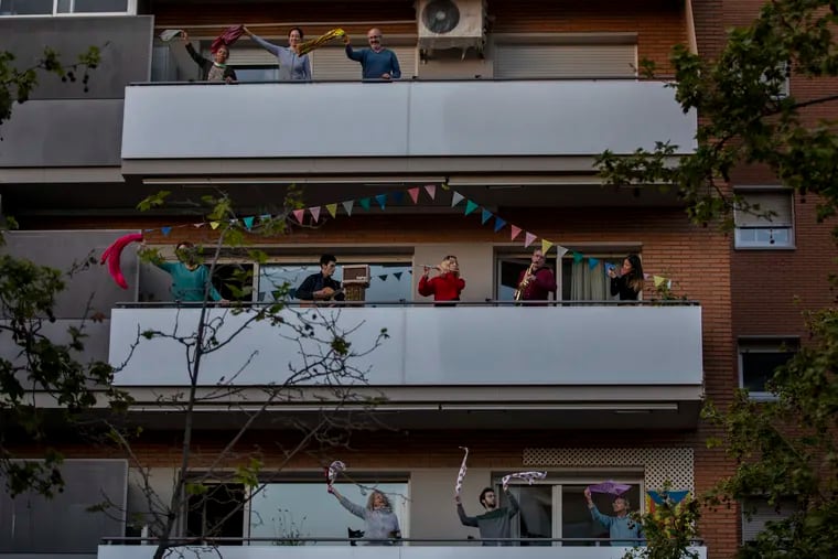 People play instruments as other dance on their balconies in support of the medical staff that are working on the COVID-19 virus outbreak in Barcelona, Spain, on April 5.