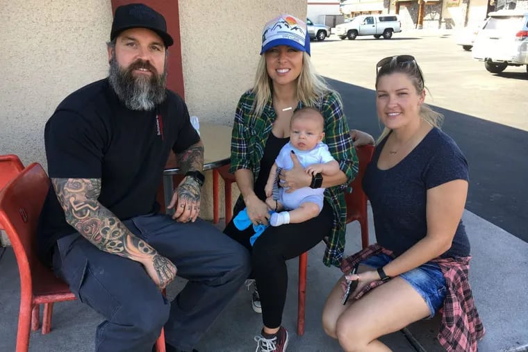 Jesse Jorgensen, his wife Vonya and son Rhett and their friend Cassidy Ziegler outside Studio 21 Tattoos.