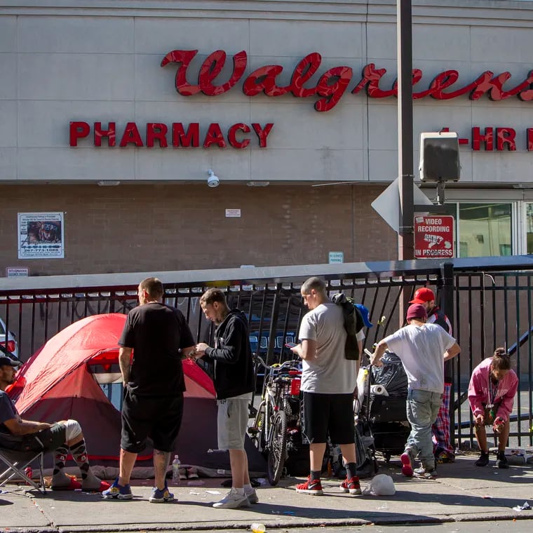 A group of people gather on Kensington Avenue outside a Walgreens in 2021. The pharmaceutical giant agreed to pay the city of Philadelphia $110 million over five years in a settlement of a lawsuit over its role in the opioid crisis.